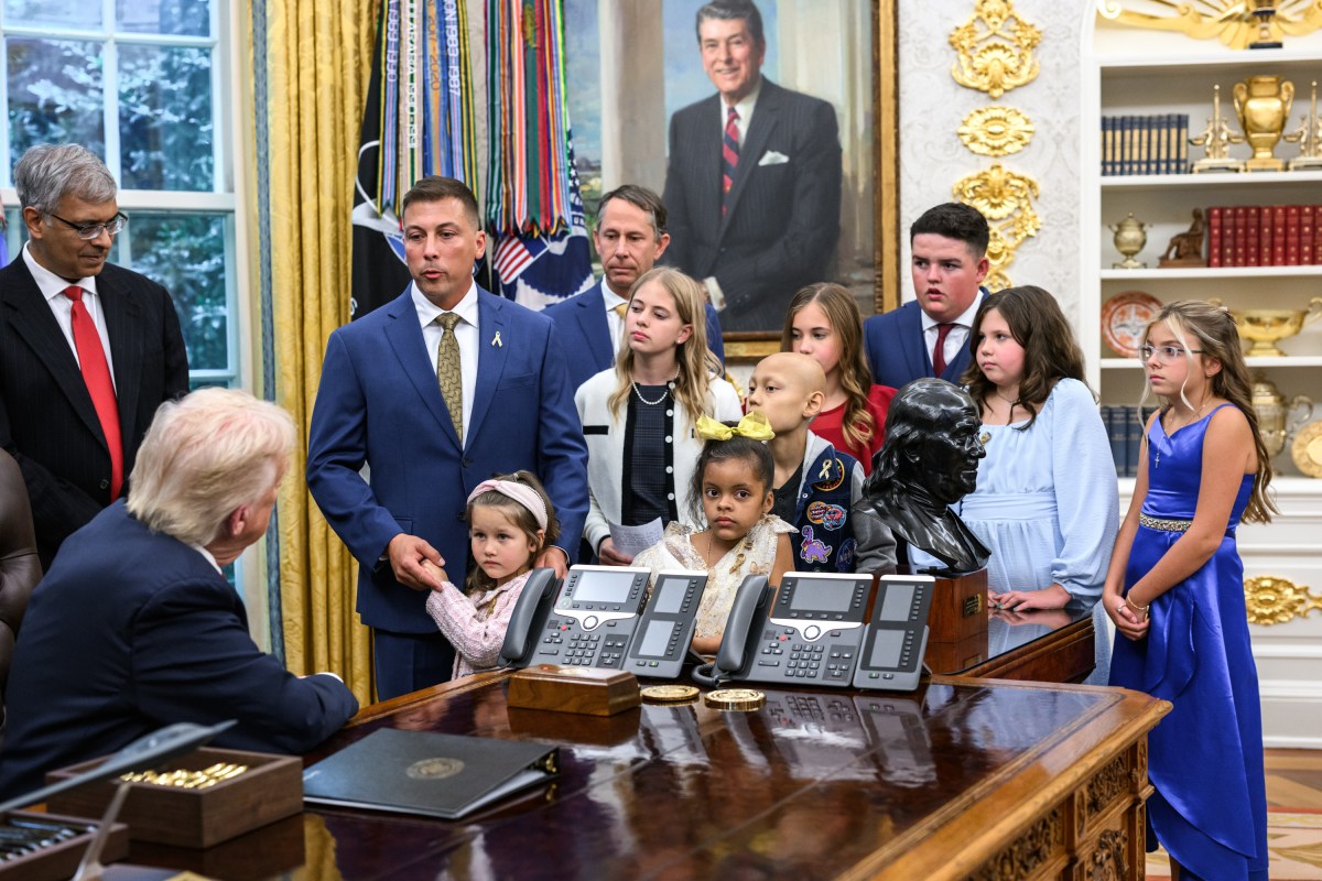 President Donald Trump, joined by HHS Secretary Robert F. Kennedy, Jr. and children affected by cancer and their families, signs an Executive Order to accelerate pediatric cancer research, Tuesday, September 30, 2025, in the Oval Office. (Official White House Photo by Molly Riley)