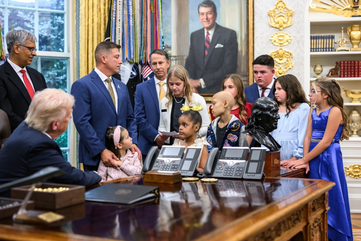 President Donald Trump, joined by HHS Secretary Robert F. Kennedy, Jr. and children affected by cancer and their families, signs an Executive Order to accelerate pediatric cancer research, Tuesday, September 30, 2025, in the Oval Office. (Official White House Photo by Molly Riley)