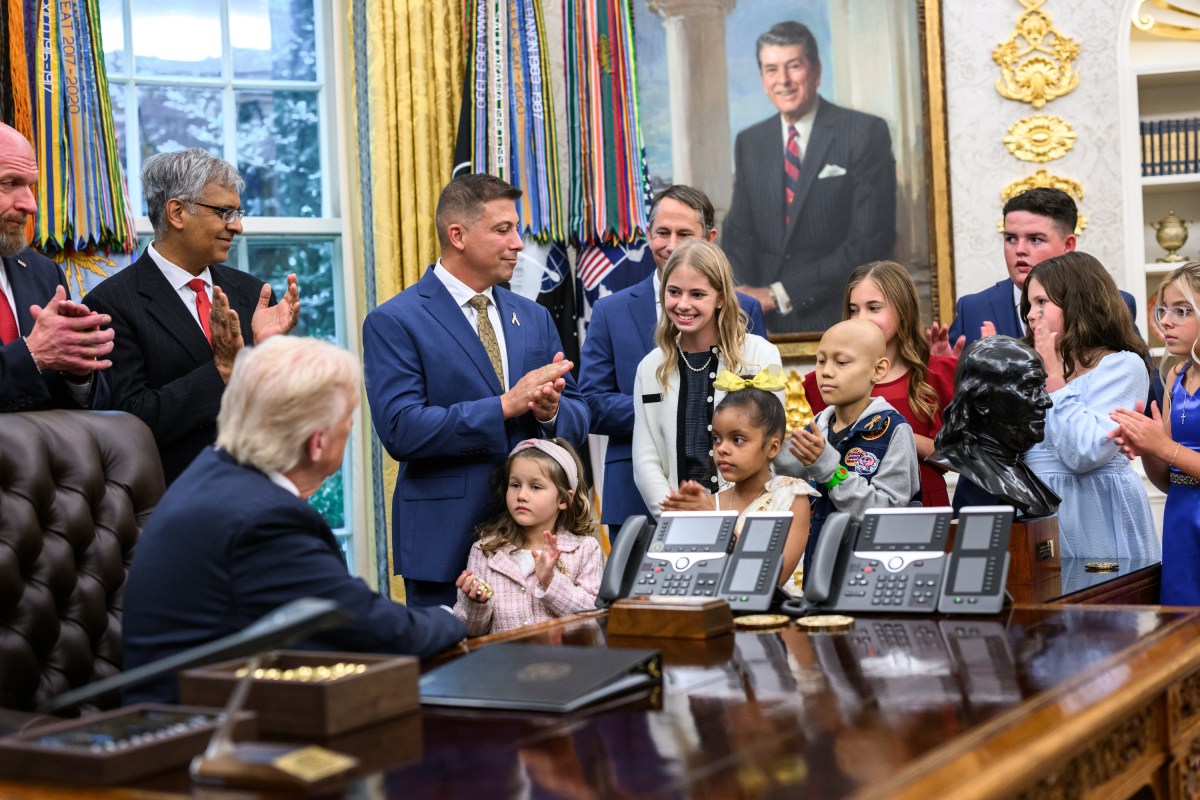 President Donald Trump, joined by HHS Secretary Robert F. Kennedy, Jr. and children affected by cancer and their families, signs an Executive Order to accelerate pediatric cancer research, Tuesday, September 30, 2025, in the Oval Office. (Official White House Photo by Molly Riley)