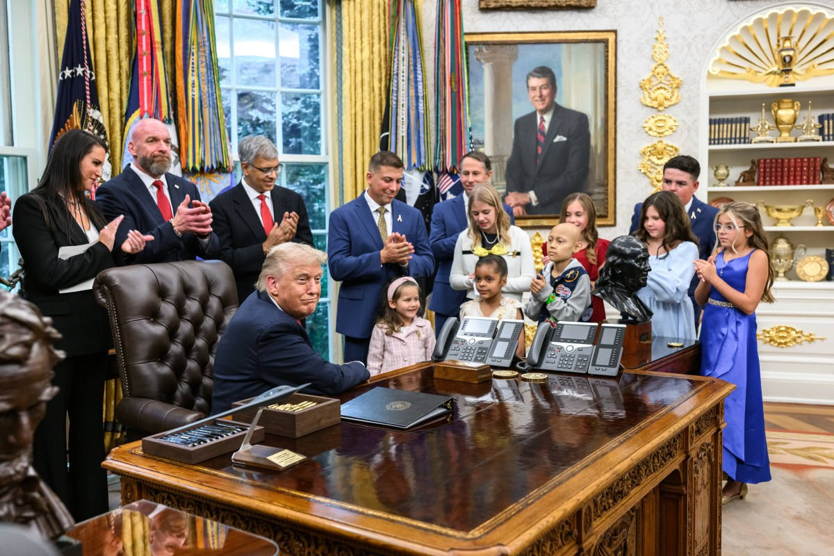 President Donald Trump, joined by HHS Secretary Robert F. Kennedy, Jr. and children affected by cancer and their families, signs an Executive Order to accelerate pediatric cancer research, Tuesday, September 30, 2025, in the Oval Office. (Official White House Photo by Molly Riley)