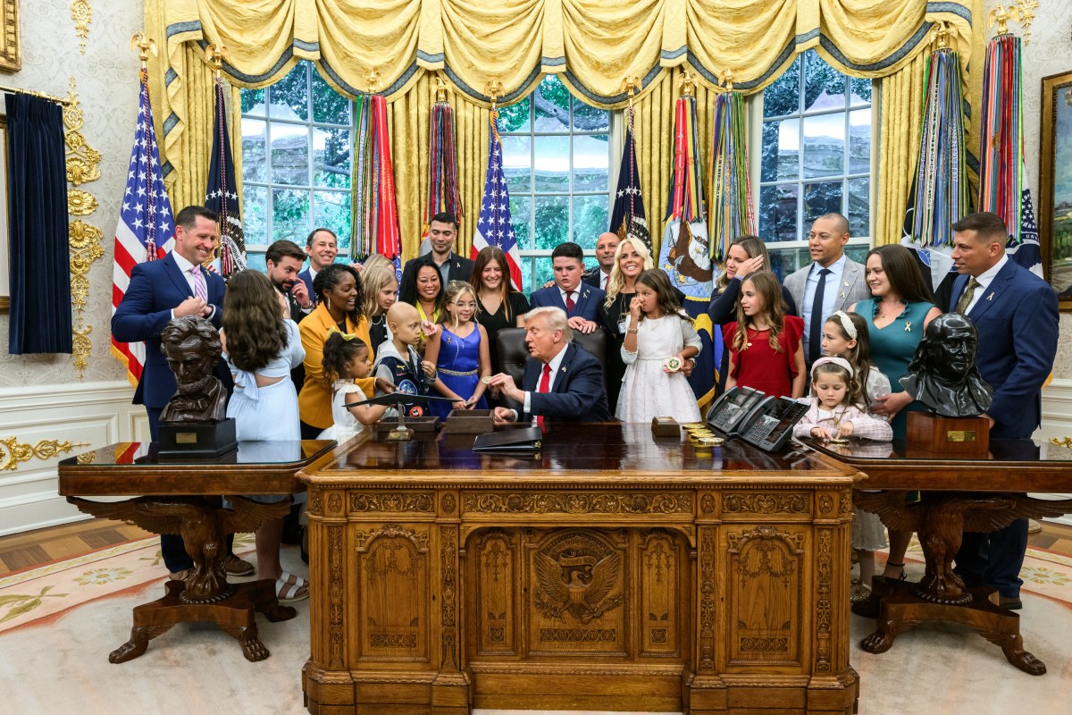 President Donald Trump, joined by HHS Secretary Robert F. Kennedy, Jr. and children affected by cancer and their families, signs an Executive Order to accelerate pediatric cancer research, Tuesday, September 30, 2025, in the Oval Office. (Official White House Photo by Molly Riley)