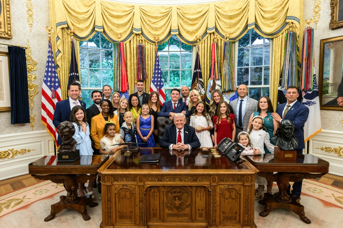 President Donald Trump, joined by HHS Secretary Robert F. Kennedy, Jr. and children affected by cancer and their families, signs an Executive Order to accelerate pediatric cancer research, Tuesday, September 30, 2025, in the Oval Office. (Official White House Photo by Molly Riley)