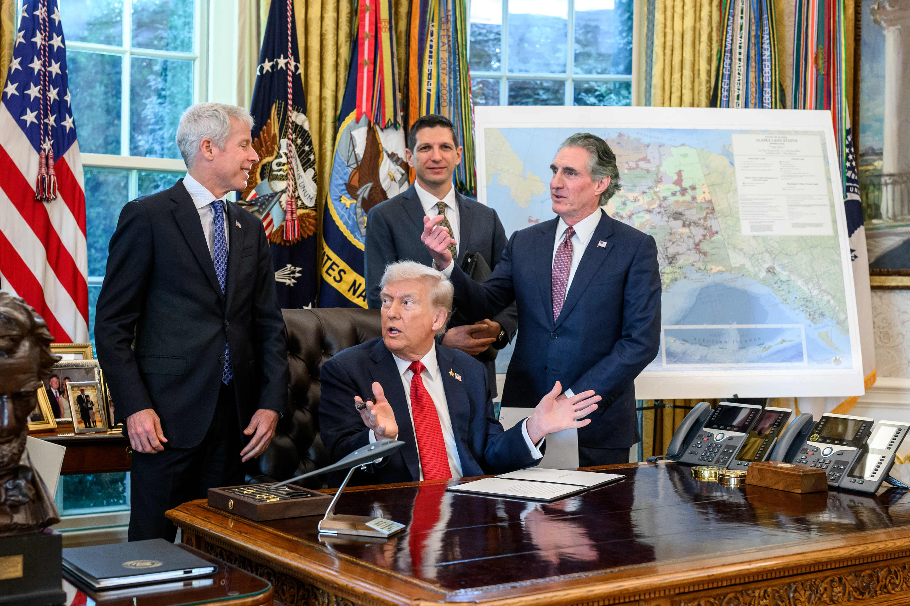 President Donald Trump signs an Executive Order approving the