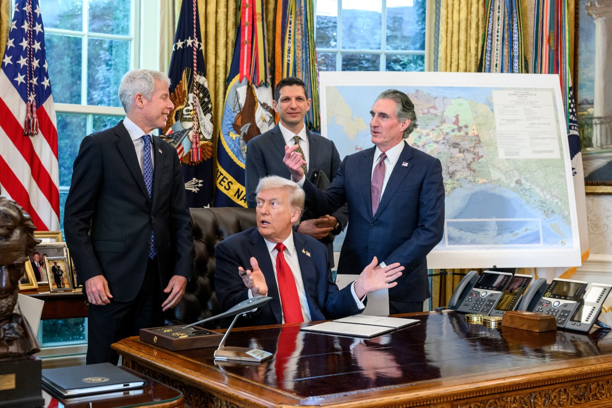 President Donald Trump, flanked by Secretary of Energy Chris Wright and Secretary of the Interior Doug Burgum, signs an Executive Order approving the Ambler Road Project in Alaska, Monday, October 6, 2025, in the Oval Office. (Official White House Photo by Joyce N. Boghosian)