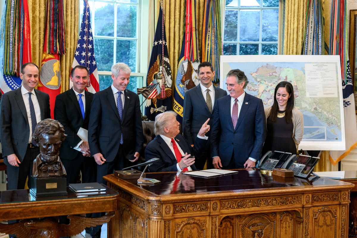 President Donald Trump, flanked by Secretary of Energy Chris Wright and Secretary of the Interior Doug Burgum, signs an Executive Order approving the Ambler Road Project in Alaska, Monday, October 6, 2025, in the Oval Office. (Official White House Photo by Joyce N. Boghosian)