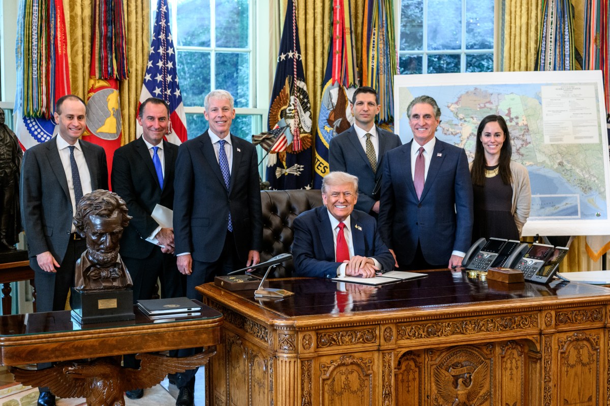 President Donald Trump, flanked by Secretary of Energy Chris Wright and Secretary of the Interior Doug Burgum, signs an Executive Order approving the Ambler Road Project in Alaska, Monday, October 6, 2025, in the Oval Office. (Official White House Photo by Joyce N. Boghosian)