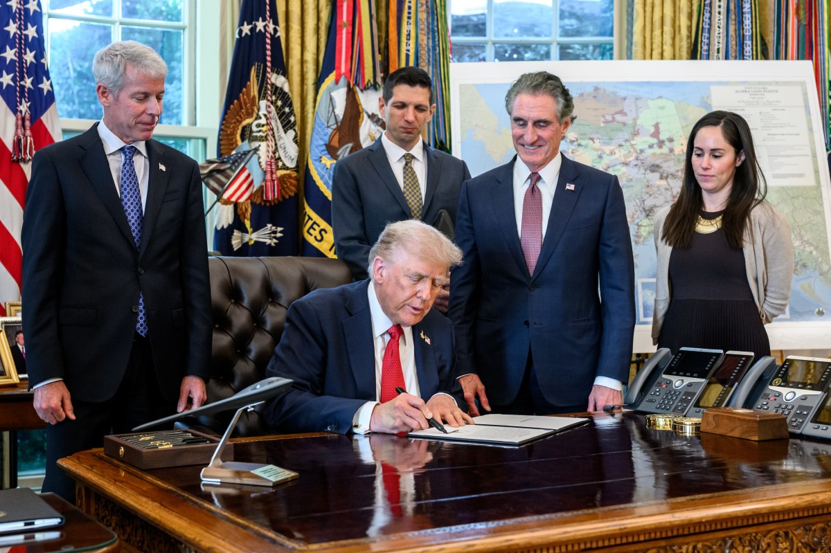 President Donald Trump, flanked by Secretary of Energy Chris Wright and Secretary of the Interior Doug Burgum, signs an Executive Order approving the Ambler Road Project in Alaska, Monday, October 6, 2025, in the Oval Office. (Official White House Photo by Joyce N. Boghosian)