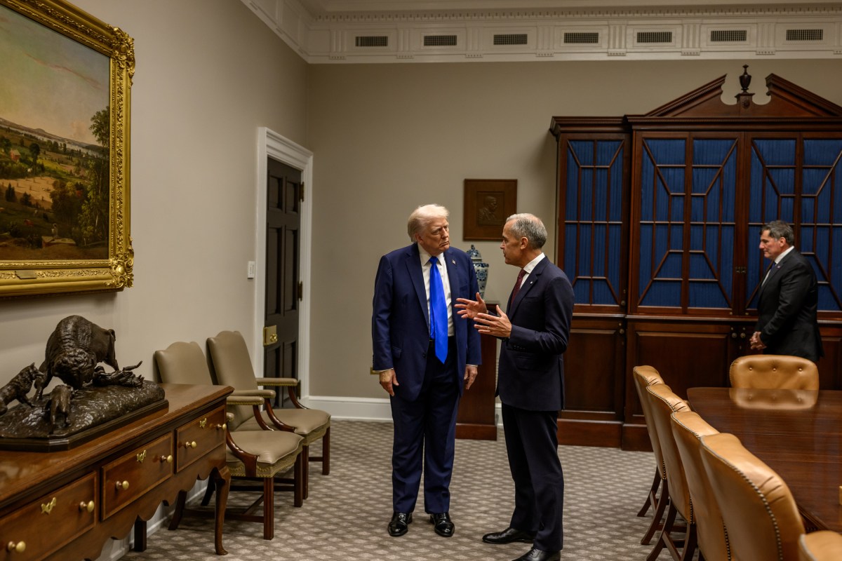 President Donald Trump looks on as Canadian Prime Minister Mark Carney signs the guest book in the Roosevelt Room before a meeting with President Donald Trump, Tuesday, October 7, 2025. (Official White House Photo by Daniel Torok)