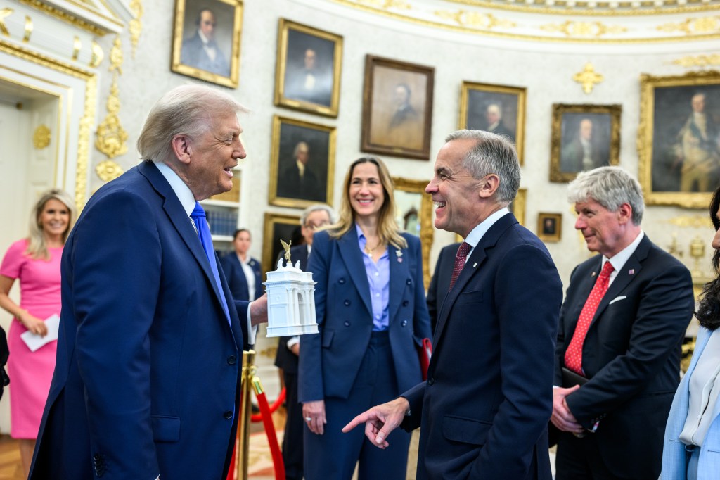 President Donald Trump shows Canadian Prime Minister Mark Carney a model of the proposed “Independence Arch” before their meeting in the Oval Office, Tuesday, October 7, 2025. (Official White House Photo by Daniel Torok)