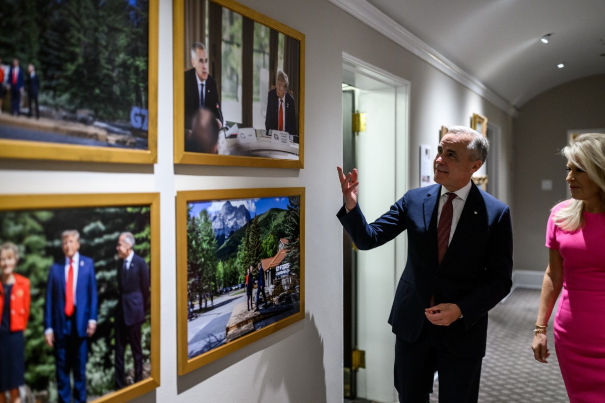 Canadian Prime Minister Mark Carney looks at photos in the White House alongside Chief of Protocol Monica Crowley, Tuesday, October 7, 2025. (Official White House Photo by Daniel Torok)