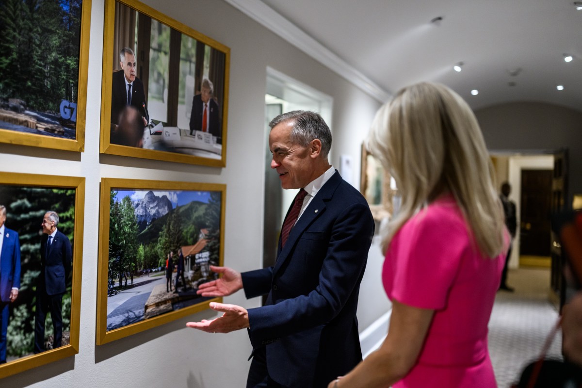 Canadian Prime Minister Mark Carney looks at photos in the White House alongside Chief of Protocol Monica Crowley, Tuesday, October 7, 2025. (Official White House Photo by Daniel Torok)
