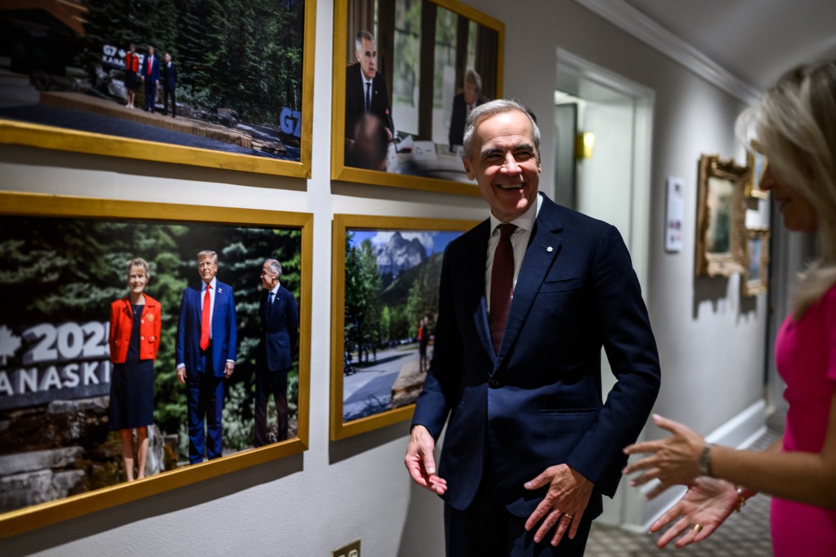Canadian Prime Minister Mark Carney looks at photos in the White House alongside Chief of Protocol Monica Crowley, Tuesday, October 7, 2025. (Official White House Photo by Daniel Torok)
