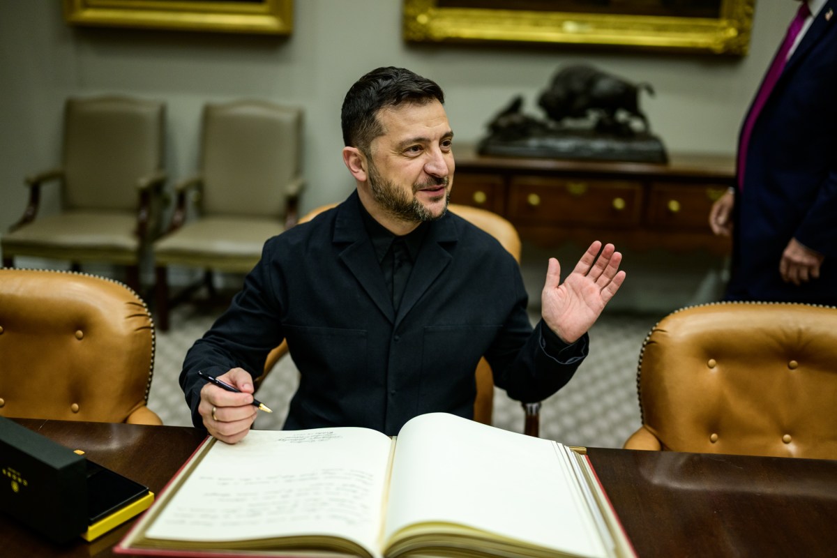 President Donald Trump looks on as Ukrainian President Volodymyr Zelenskyy signs the guestbook in the Roosevelt Room, Friday, October 17, 2025. (Official White House Photo by Daniel Torok)