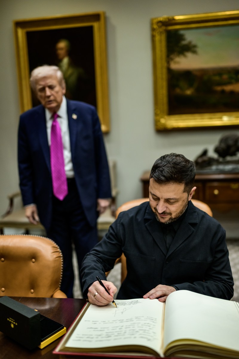 President Donald Trump looks on as Ukrainian President Volodymyr Zelenskyy signs the guestbook in the Roosevelt Room, Friday, October 17, 2025. (Official White House Photo by Daniel Torok)
