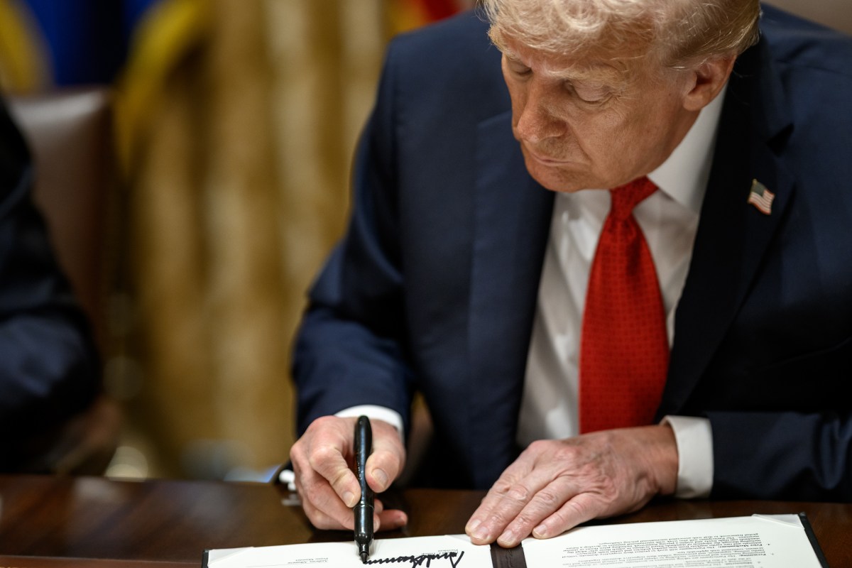 President Donald Trump signs a mineral agreement during a bilateral meeting with Australian Prime Minister Anthony Albanese in the Cabinet Room, Monday, October 20, 2025. (Official White House Photo by Daniel Torok)