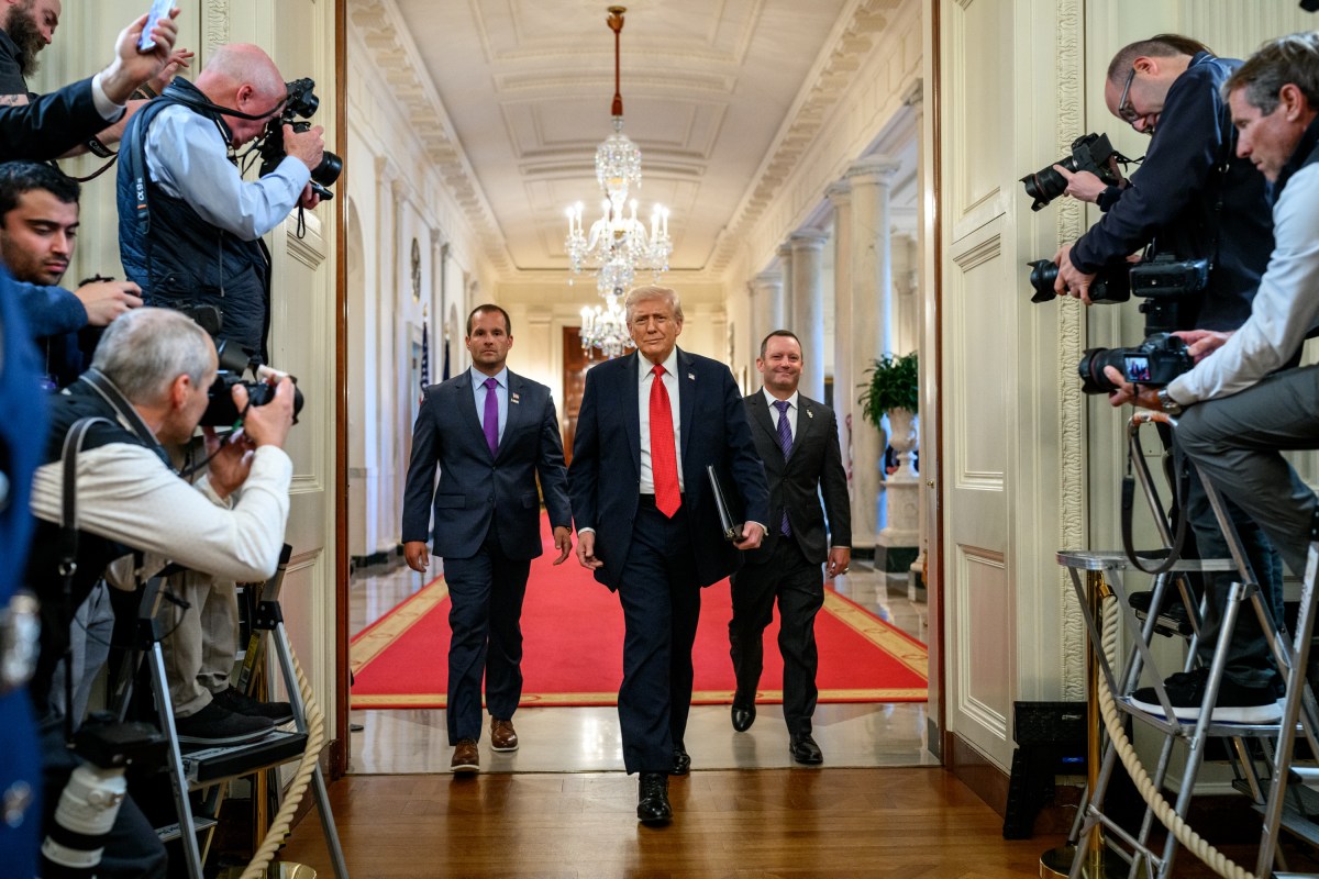 President Donald Trump arrives to the East Room of the White House with Louisiana State University Tigers head coach Jay Johnson and LSU Shreveport Pilots head coach Brad Neffendorf for a 2025 College World Series Championship celebration, Monday, October 20, 2025. (Official White House Photo by Molly Riley)