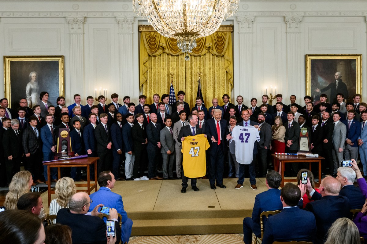 Louisiana State University Tigers head coach Jay Johnson and LSU Shreveport Pilots head coach Brad Neffendorf present commemorative jerseys to President Donald Trump at a 2025 College World Series Championship celebration, Monday, October 20, 2025, in the East Room. (Official White House Photo by Molly Riley)