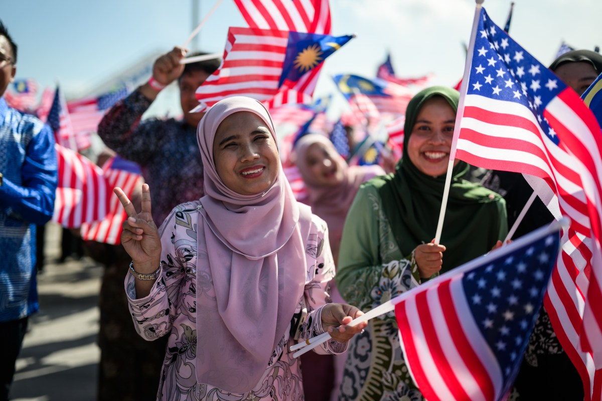 Crowds wave flags and cheer during an arrival ceremony for President Donald Trump at Kuala Lumpur International Airport Sunday, October 25, 2025, in Kuala Lumpur, Malaysia. (Official White House Photo by Daniel Torok)