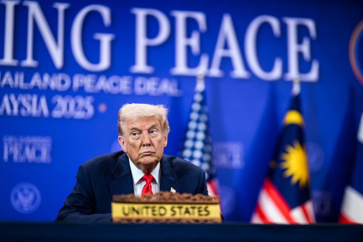 President Donald Trump looks on as Malaysian Prime Minister Seri Anwar Ibrahim delivers remarks before signing the Kuala Lumpur Accord, Sunday, October 25, 2025, at the ASEAN Summit in Kuala Lumpur, Malaysia. (Official White House Photo by Daniel Torok)