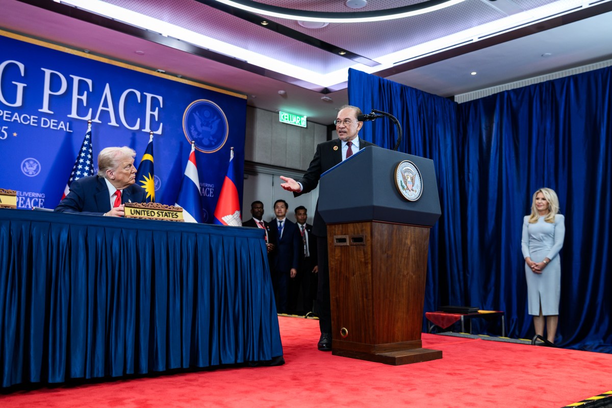 President Donald Trump looks on as Malaysian Prime Minister Seri Anwar Ibrahim delivers remarks before signing the Kuala Lumpur Accord, Sunday, October 25, 2025, at the ASEAN Summit in Kuala Lumpur, Malaysia. (Official White House Photo by Daniel Torok)
