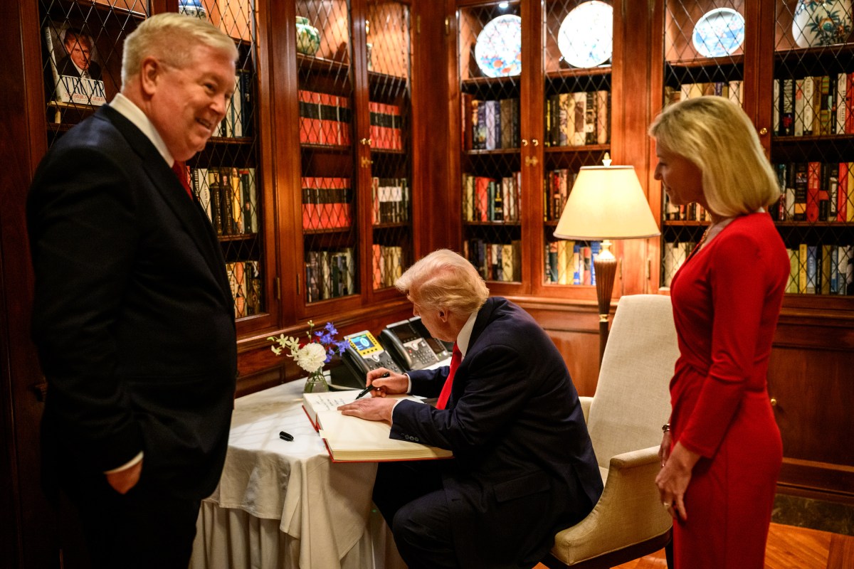President Donald Trump signs the guest book at the ambassador’s residence in Tokyo, Japan on Tuesday, October 28, 2025, as Secretary of Commerce Howard Lutnick, Ambassador George Glass, and his wife, Mary Glass, look on. (Official White House Photo by Molly Riley)