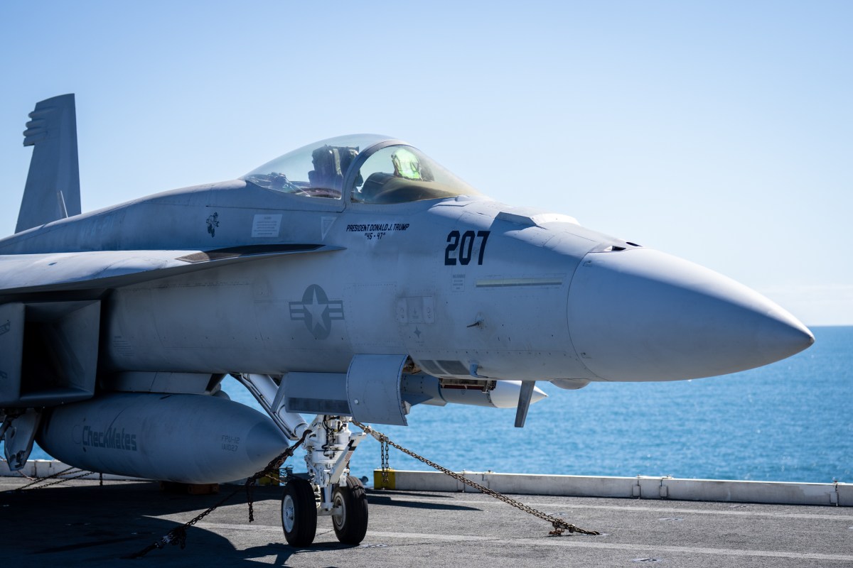 A military jet adorned with U.S. President Donald Trump's name is seen aboard the USS George H.W. Bush aircraft carrier after observing naval flight demonstrations on October 5, 2025 off the eastern coast of the United States. President Trump is visiting Naval Station Norfolk in Virginia for a celebration of the 250th birthday of the U.S. Navy. (Official White House Photo by Andrea Hanks)