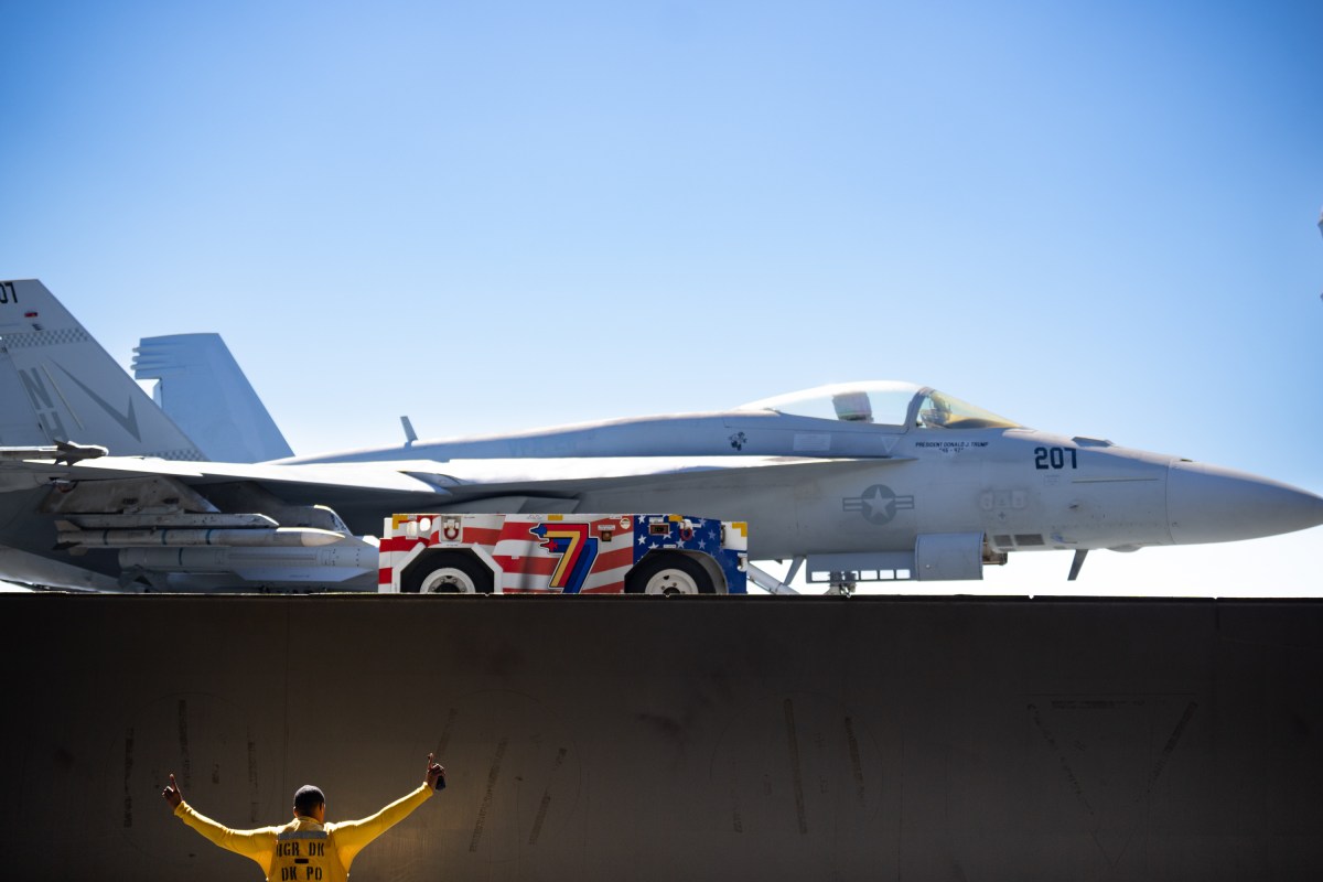 A military jet adorned with U.S. President Donald Trump's name is seen aboard the USS George H.W. Bush aircraft carrier after observing naval flight demonstrations on October 5, 2025 off the eastern coast of the United States. President Trump is visiting Naval Station Norfolk in Virginia for a celebration of the 250th birthday of the U.S. Navy. (Official White House Photo by Andrea Hanks)
