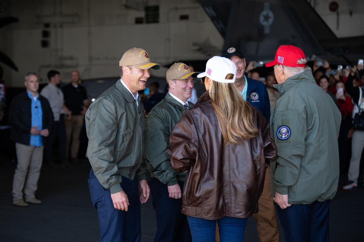 President Donald Trump and First Lady Melania Trump speaks with Secretary of War Pete Hegseth and Navy Secretary John Phelan on board the USS George H.W. Bush before viewing a naval sea power demonstration, Sunday, October 5, 2025. (Official White House Photo by Andrea Hanks)