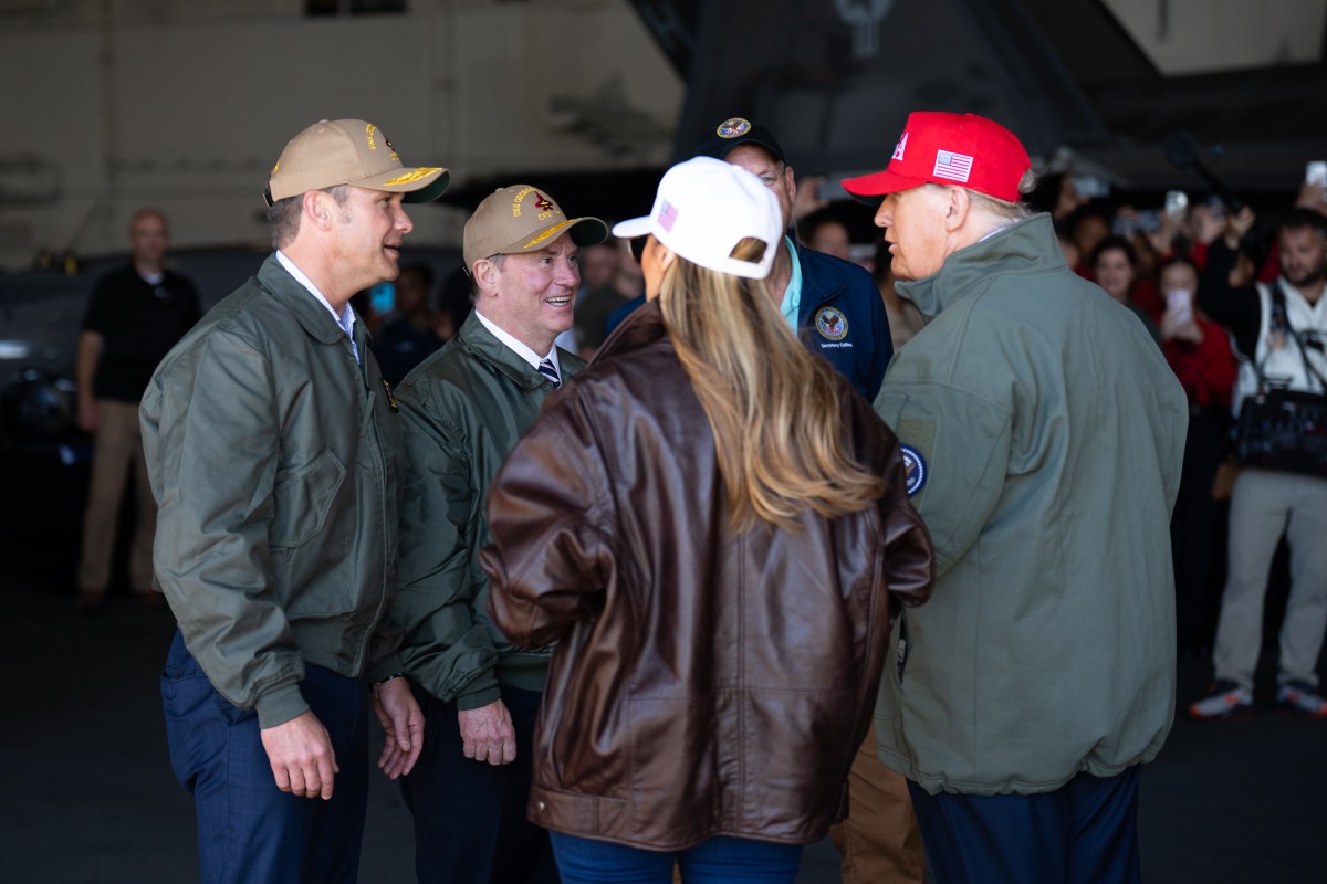 President Donald Trump and First Lady Melania Trump speaks with Secretary of War Pete Hegseth and Navy Secretary John Phelan on board the USS George H.W. Bush before viewing a naval sea power demonstration, Sunday, October 5, 2025. (Official White House Photo by Andrea Hanks)