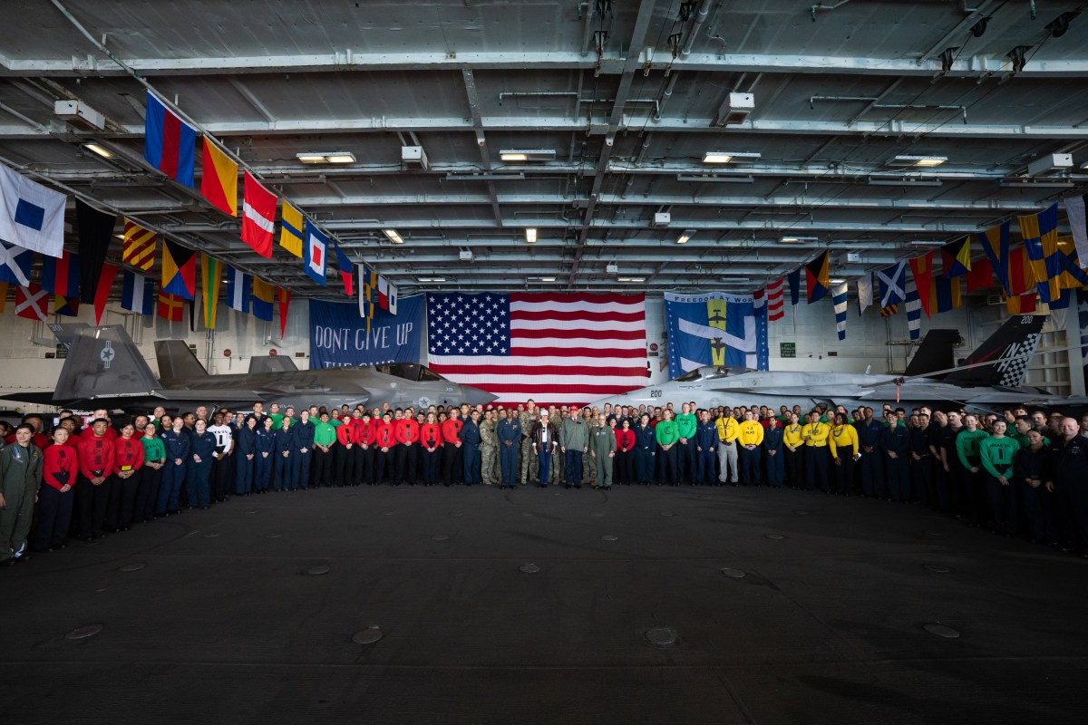 President Donald Trump and First Lady Melania Trump pose for photos with U.S. Navy sailors stationed aboard the aircraft carrier USS George H.W. Bush, Sunday, October 5, 2025, in Norfolk, Virginia. (Official White House Photo by Andrea Hanks)