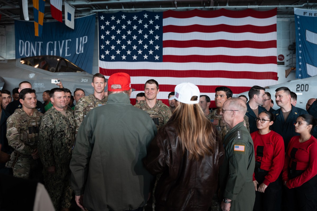President Donald Trump and First Lady Melania Trump speak with U.S. Navy sailors stationed aboard the aircraft carrier USS George H.W. Bush after posing for photos, Sunday, October 5, 2025, in Norfolk, Virginia. (Official White House Photo by Andrea Hanks)