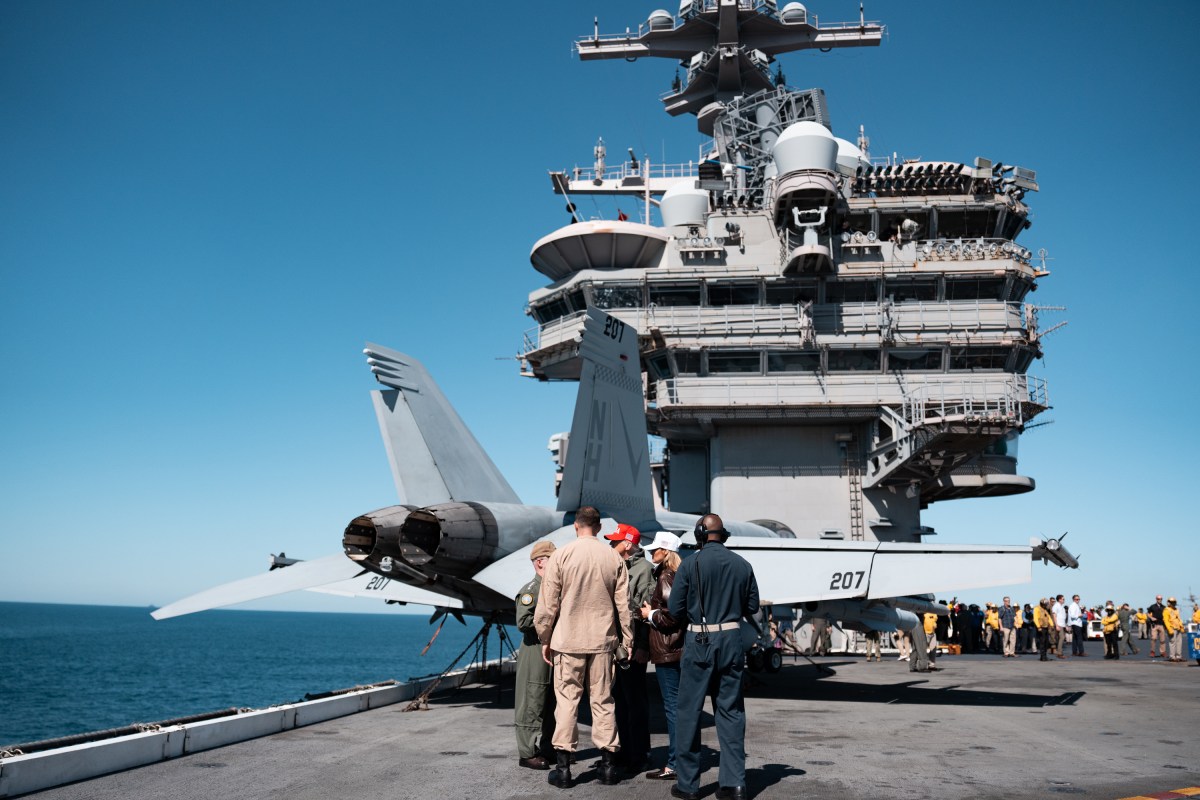 President Donald Trump and First Lady Melania Trump speak with Chief of Naval Operations Admiral Daryl Caudle and others during naval sea power demonstrations in honor of the 250th anniversary of the U.S. Navy, Sunday, October 5, 2025, aboard the USS George H.W. Bush in the Atlantic Ocean off the coast of Norfolk, Virginia. (Official White House Photo by Andrea Hanks)
