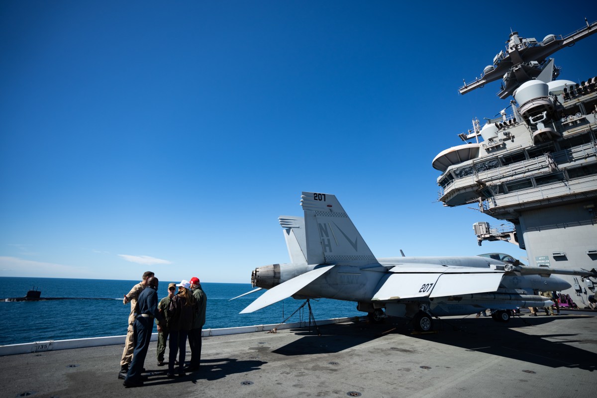 President Donald Trump and First Lady Melania Trump speak with Chief of Naval Operations Admiral Daryl Caudle and others during naval sea power demonstrations in honor of the 250th anniversary of the U.S. Navy, Sunday, October 5, 2025, aboard the USS George H.W. Bush in the Atlantic Ocean off the coast of Norfolk, Virginia. (Official White House Photo by Andrea Hanks)