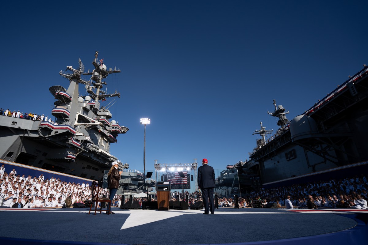 US President Donald Trump and US First Lady Melania Trump walk onstage to deliver remarks during a visit to the USS Harry S. Truman during the US Navy's 250th anniversary celebration, "America's Navy 250: Titans of the Sea - A Salute to the Fleet", at Naval Station Norfolk Pier 14 in Norfolk, Virginia on October 5, 2025. (Official White House Photo by Andrea Hanks)