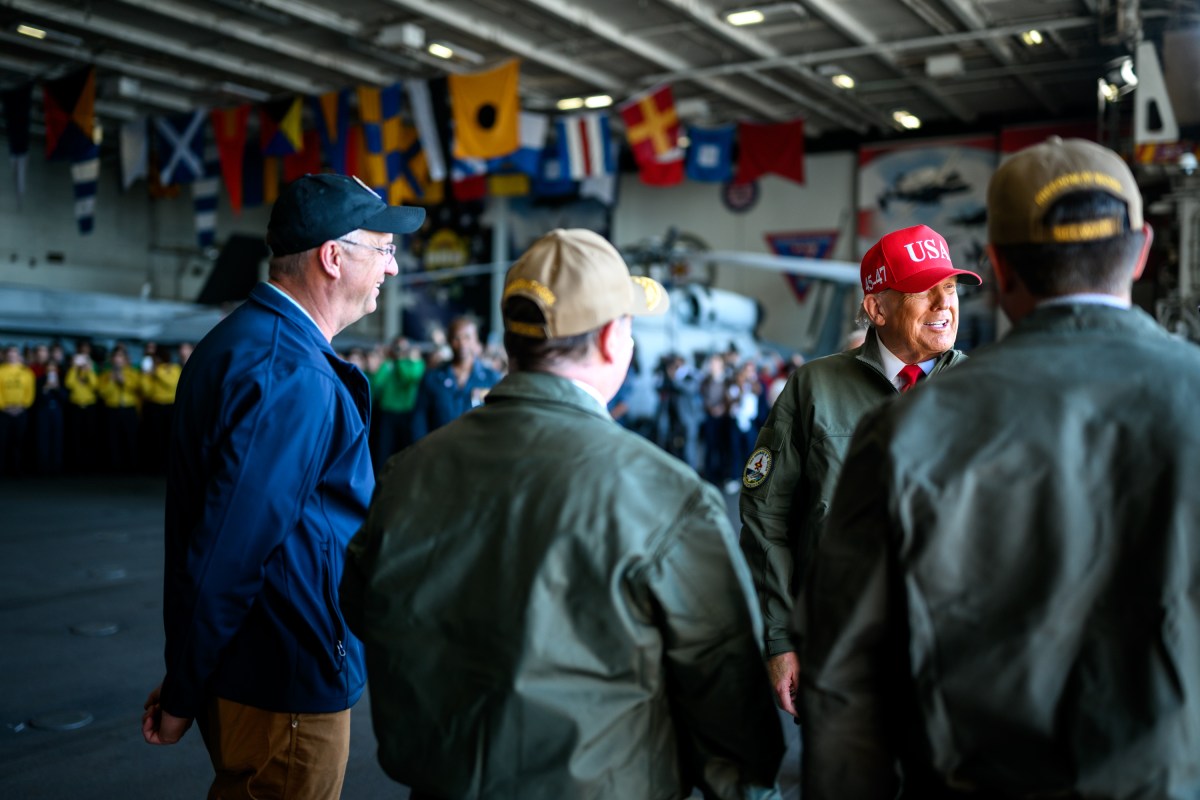 President Donald Trump and First Lady Melania Trump speaks with Secretary of War Pete Hegseth and Navy Secretary John Phelan on board the USS George H.W. Bush before viewing a naval sea power demonstration, Sunday, October 5, 2025. (Official White House Photo by Daniel Torok)