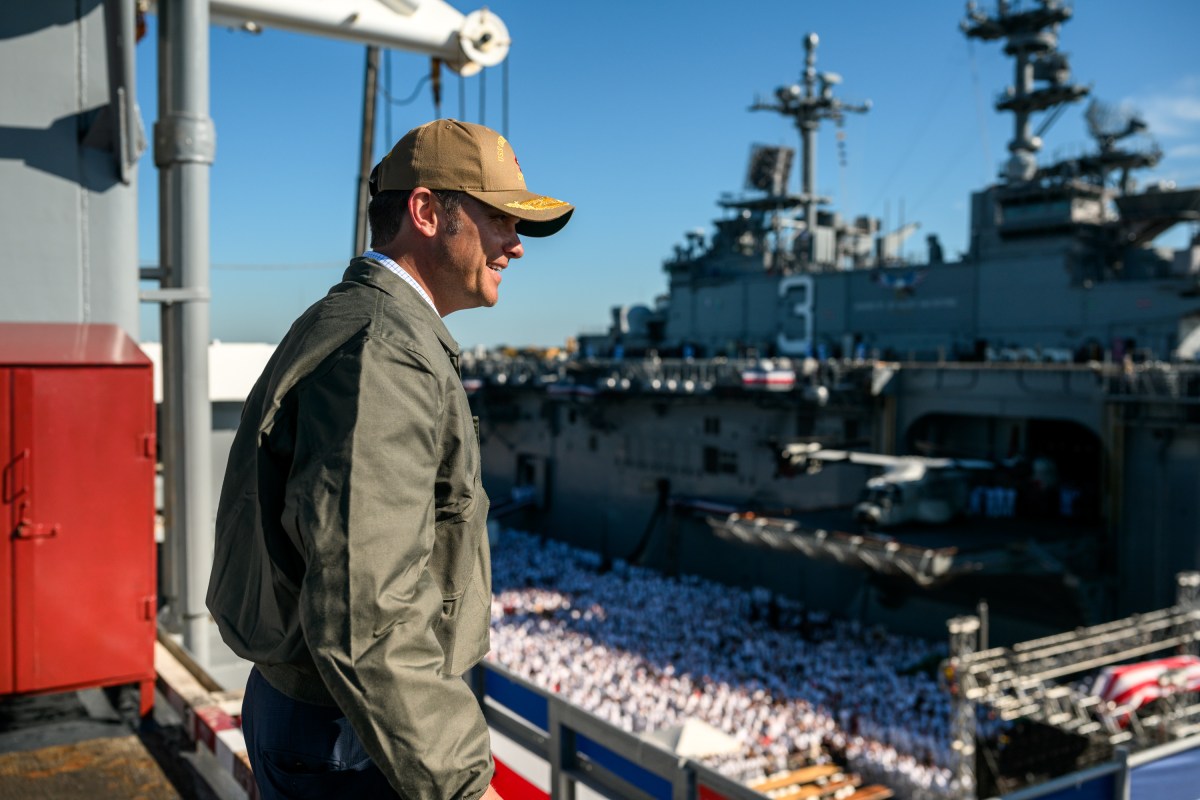 Secretary of War Pete Hegseth looks at U.S. Navy sailors gathered to watch President Donald Trump deliver remarks at the U.S. Navy 250th anniversary celebration at Naval Station Norfolk in Norfolk, Virginia, Sunday, October 5, 2025. (Official White House Photo by Daniel Torok)