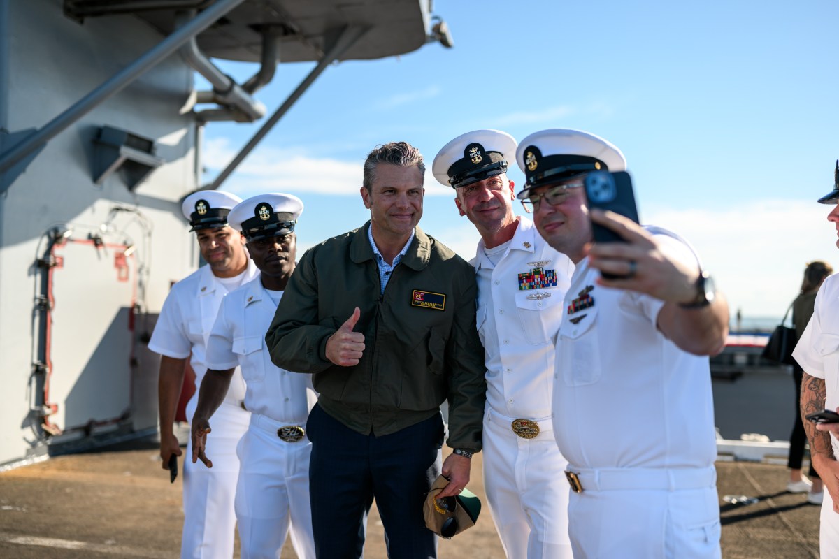 Secretary of War Pete Hegseth poses for photos with sailors before President Donald Trump delivers remarks at the U.S. Navy 250th anniversary celebration at Naval Station Norfolk in Norfolk, Virginia, Sunday, October 5, 2025. (Official White House Photo by Daniel Torok)