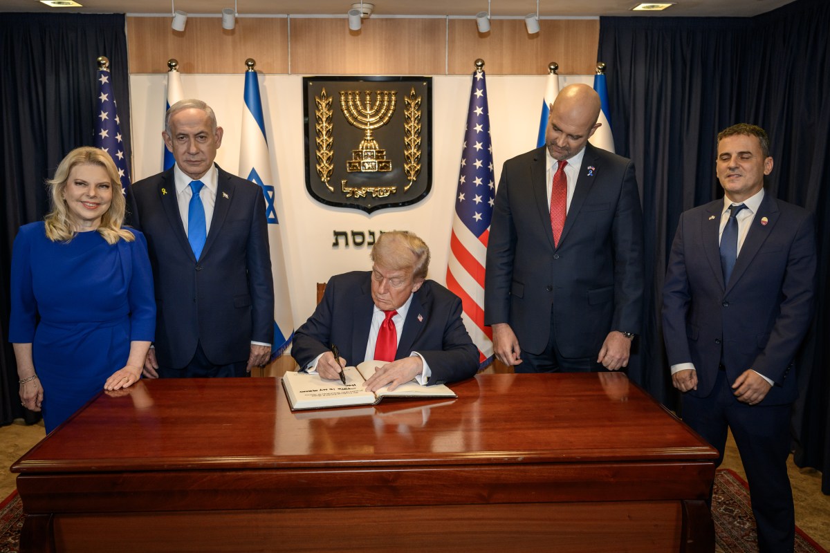 President Donald Trump signs the guestbook at the Knesset in Jerusalem, Israel, Monday, October 13, 2025, during a visit to celebrate the U.S.-brokered ceasefire and hostage release agreement between Israel and Hamas. (Official White House Photo by Daniel Torok)