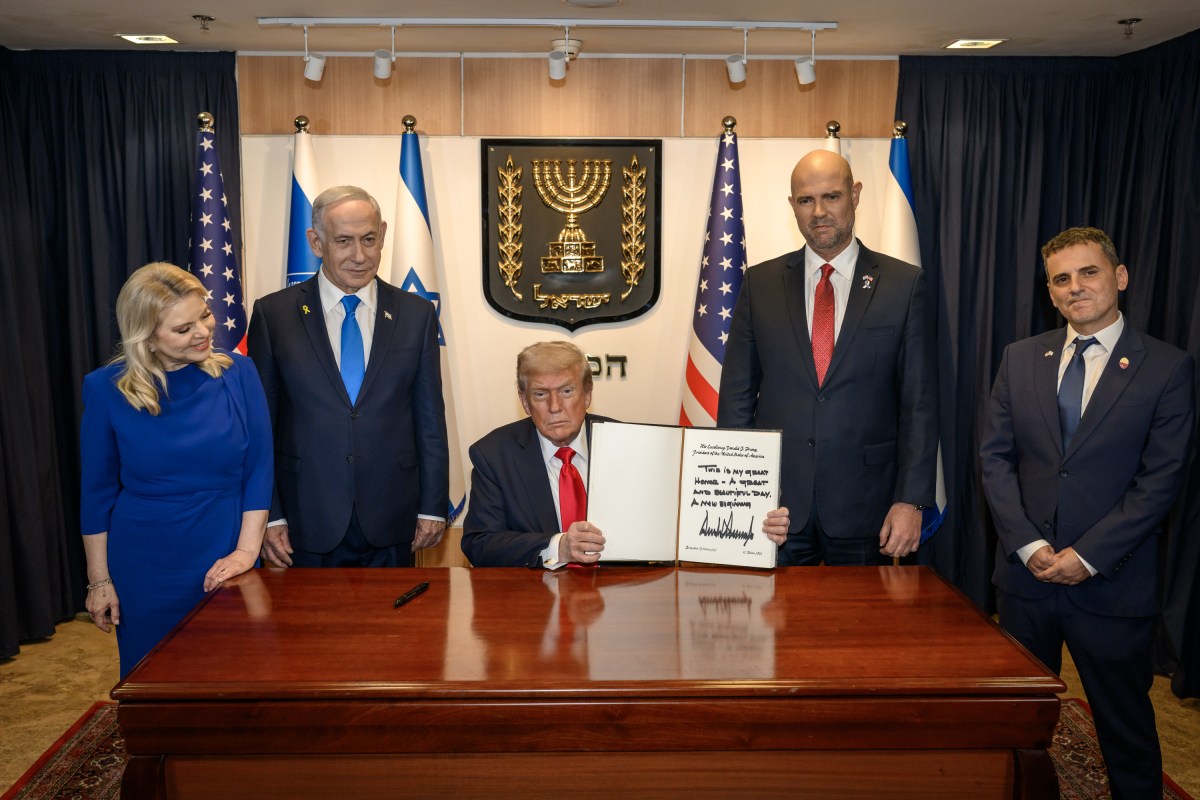 President Donald Trump signs the guestbook at the Knesset in Jerusalem, Israel, Monday, October 13, 2025, during a visit to celebrate the U.S.-brokered ceasefire and hostage release agreement between Israel and Hamas. (Official White House Photo by Daniel Torok)