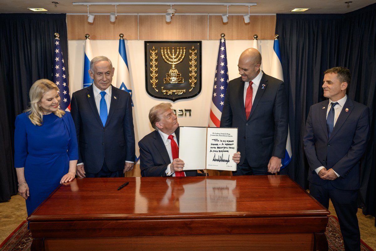 President Donald Trump signs the guestbook at the Knesset in Jerusalem, Israel, Monday, October 13, 2025, during a visit to celebrate the U.S.-brokered ceasefire and hostage release agreement between Israel and Hamas. (Official White House Photo by Daniel Torok)