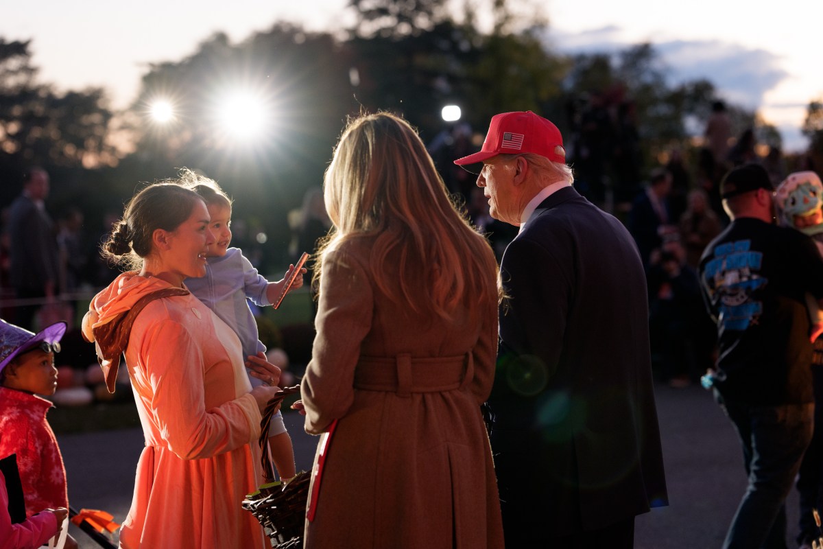 President Donald Trump and First Lady Melania Trump hand out candy to trick-or-treaters at the South Portico during Halloween celebrations at the White House, Thursday, October 30, 2025. (Official White House Photo by Andrea Hanks)