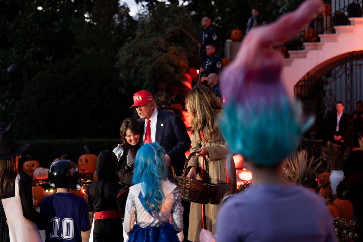 President Donald Trump and First Lady Melania Trump hand out candy to trick-or-treaters at the South Portico during Halloween celebrations at the White House, Thursday, October 30, 2025. (Official White House Photo by Andrea Hanks)