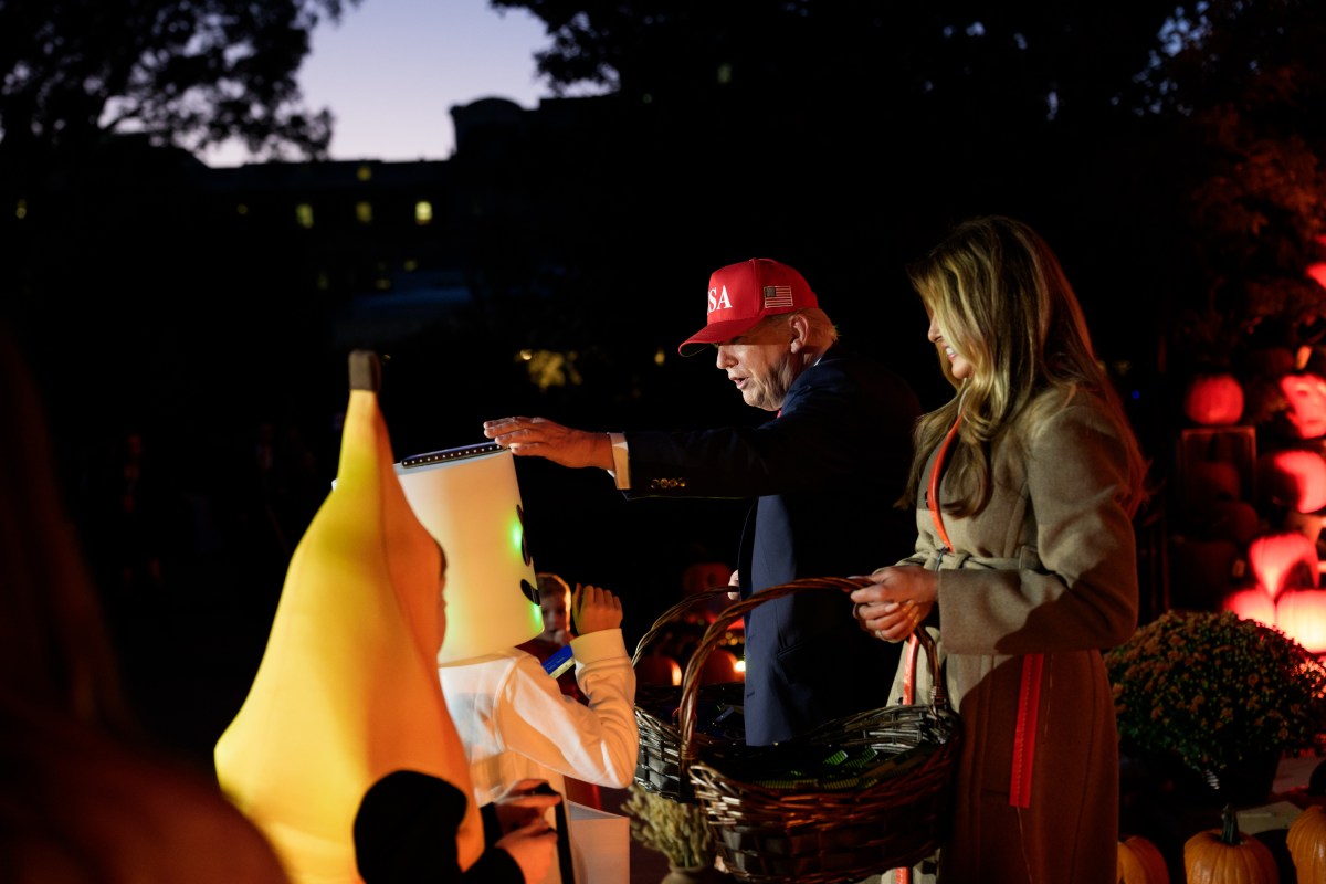 President Donald Trump and First Lady Melania Trump hand out candy to trick-or-treaters at the South Portico during Halloween celebrations at the White House, Thursday, October 30, 2025. (Official White House Photo by Andrea Hanks)