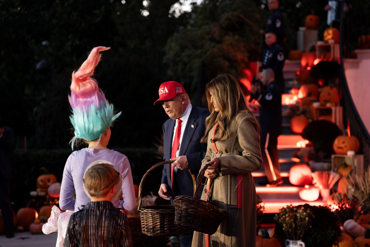 President Donald Trump and First Lady Melania Trump hand out candy to trick-or-treaters at the South Portico during Halloween celebrations at the White House, Thursday, October 30, 2025. (Official White House Photo by Andrea Hanks)