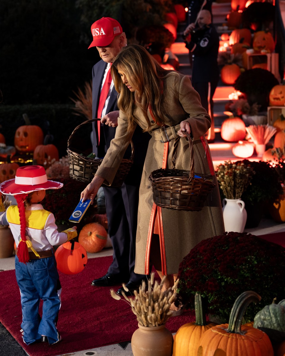 President Donald Trump and First Lady Melania Trump hand out candy to trick-or-treaters at the South Portico during Halloween celebrations at the White House, Thursday, October 30, 2025. (Official White House Photo by Andrea Hanks)
