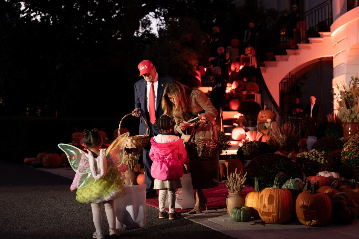President Donald Trump and First Lady Melania Trump hand out candy to trick-or-treaters at the South Portico during Halloween celebrations at the White House, Thursday, October 30, 2025. (Official White House Photo by Andrea Hanks)