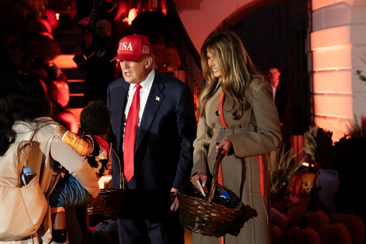 President Donald Trump and First Lady Melania Trump hand out candy to trick-or-treaters at the South Portico during Halloween celebrations at the White House, Thursday, October 30, 2025. (Official White House Photo by Andrea Hanks)