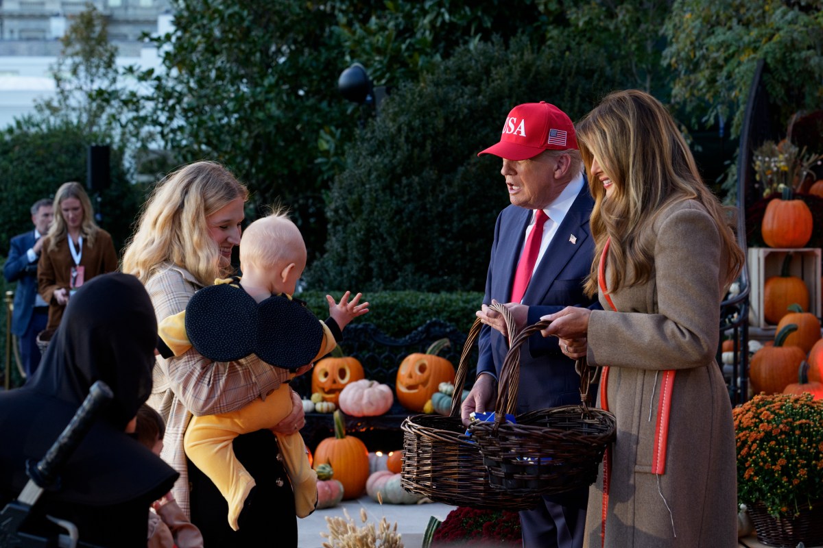 President Donald Trump and First Lady Melania Trump hand out candy to trick-or-treaters at the South Portico during Halloween celebrations at the White House, Thursday, October 30, 2025. (Official White House Photo by Andrea Hanks)