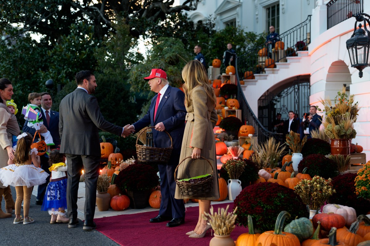 President Donald Trump and First Lady Melania Trump hand out candy to trick-or-treaters at the South Portico during Halloween celebrations at the White House, Thursday, October 30, 2025. (Official White House Photo by Andrea Hanks)
