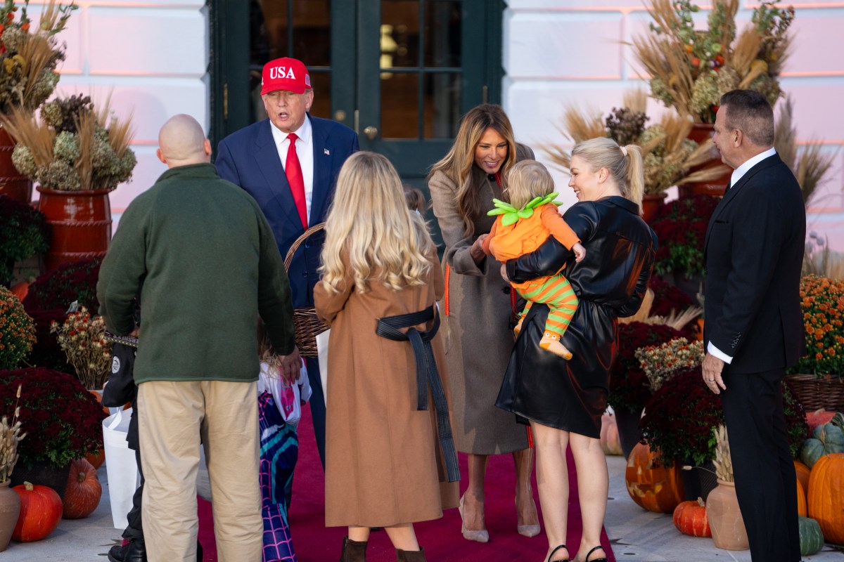 President Donald Trump and First Lady Melania Trump hand out candy to trick-or-treaters at the South Portico during Halloween celebrations at the White House, Thursday, October 30, 2025. (Official White House Photo by Cody Hendrix)